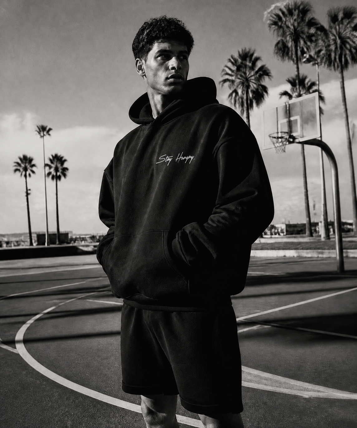 Baller Bellys campaign — athlete in a Stay Hungry hoodie on a California outdoor basketball court